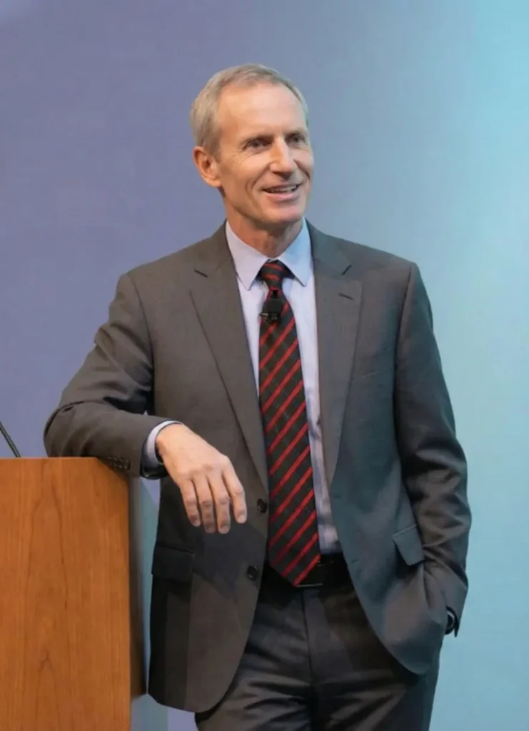 Dr. Barry Chaiken resting his arm on a speaking dais